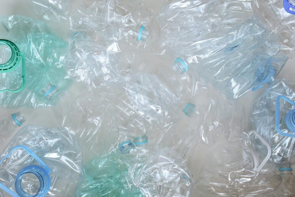 pexels-photo-3738388-3738388 An overhead shot of crushed plastic bottles ready for recycling, promoting eco-friendly practices.