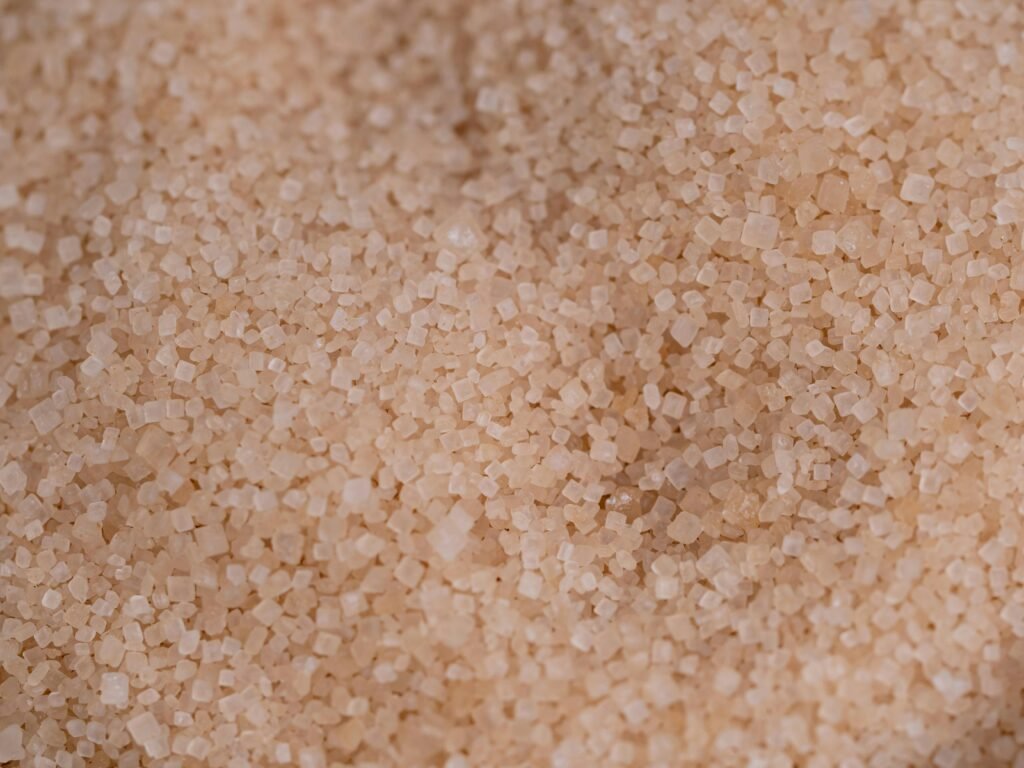Macro capture of brown cane sugar showcasing texture and detail.
